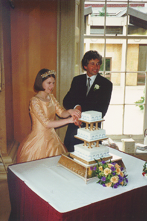 Virginia Knight and Gregory Sankaran cutting a wedding 
cake